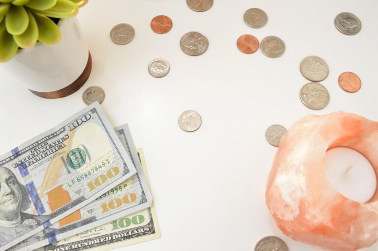 Person comparing debt snowball vs avalanche method on paper with calculator and credit card bills