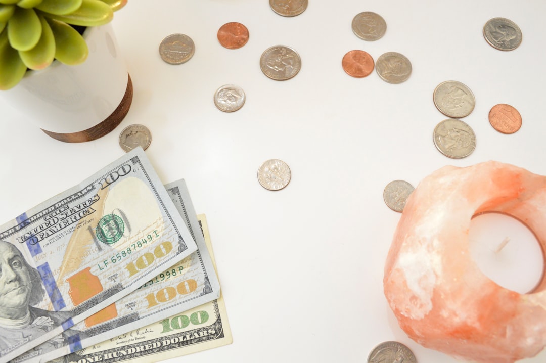 Person comparing debt snowball vs avalanche method on paper with calculator and credit card bills