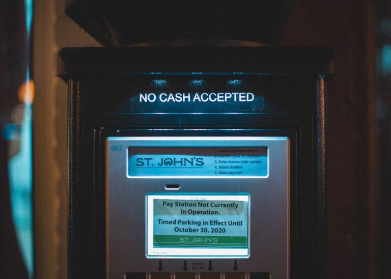 Person setting up automatic savings transfers on a phone, automating their finances for the first time