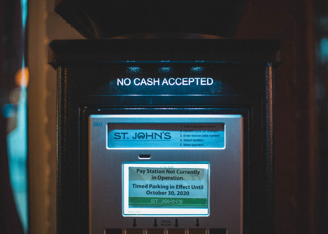 Person setting up automatic savings transfers on a phone, automating their finances for the first time