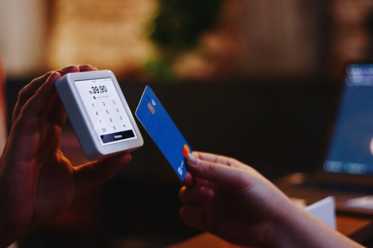 Person cutting up a credit card as part of a credit card debt payoff plan