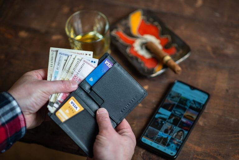 A person holding a credit card, representing the process of building credit from scratch or bad credit in 2026