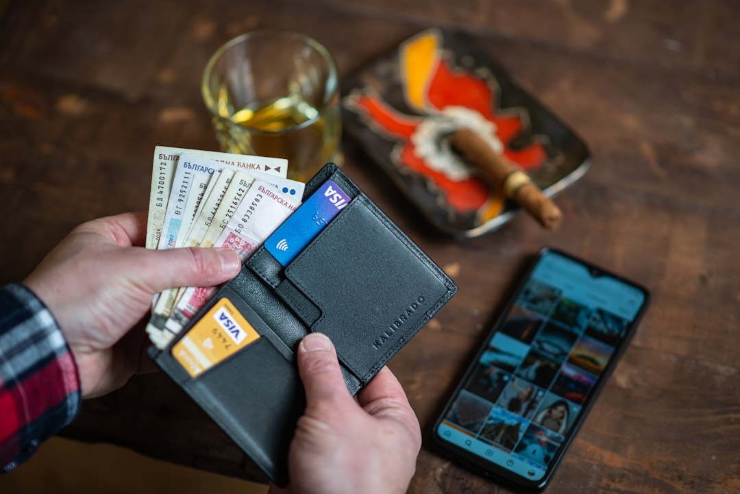 A person holding a credit card, representing the process of building credit from scratch or bad credit in 2026