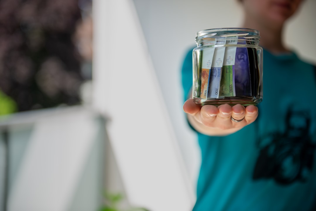 A glass jar filled with cash representing building an emergency fund from scratch