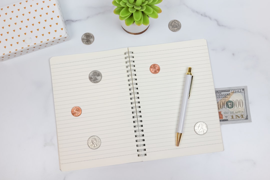 Person working through a personal finance checklist at a desk with notebook and laptop