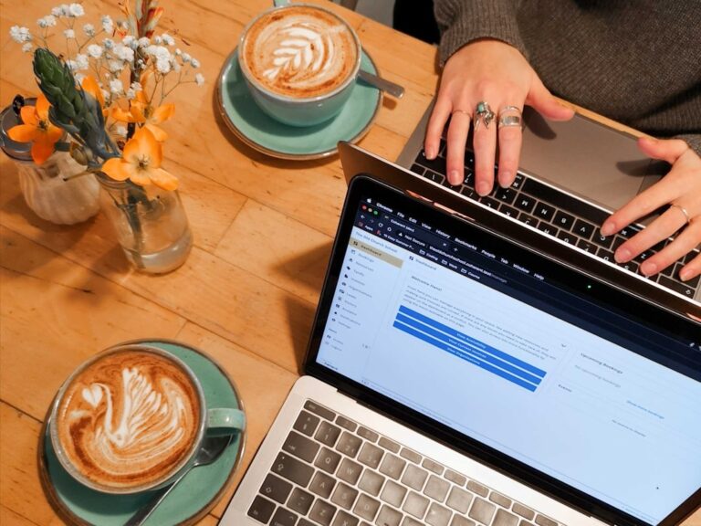 Freelancer reviewing gig work quarterly taxes on a laptop at a cafe