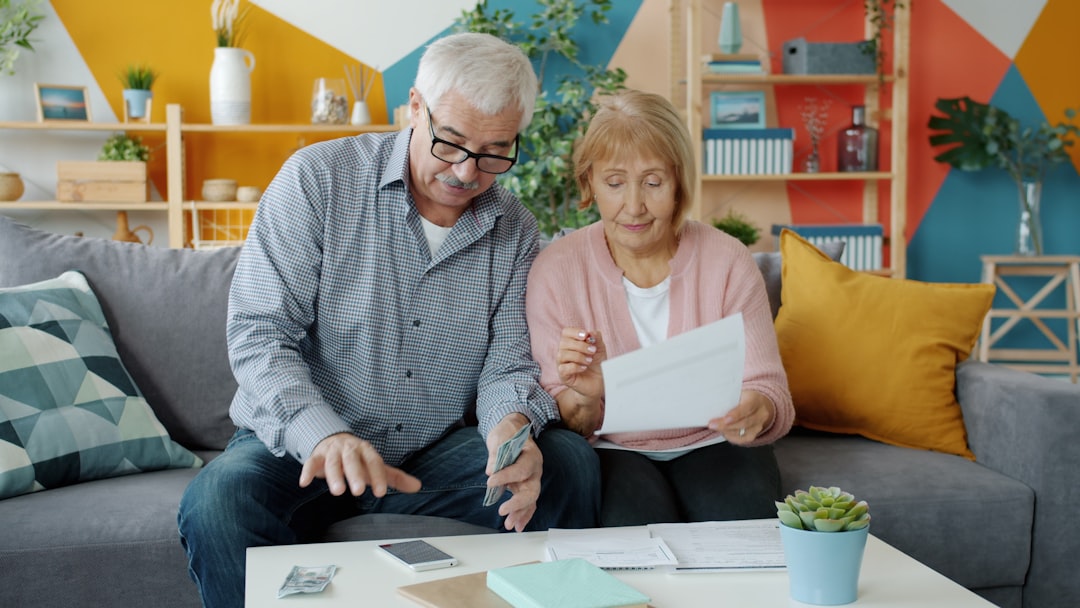 Person sitting at kitchen table reviewing financial documents while raising credit score 100 points