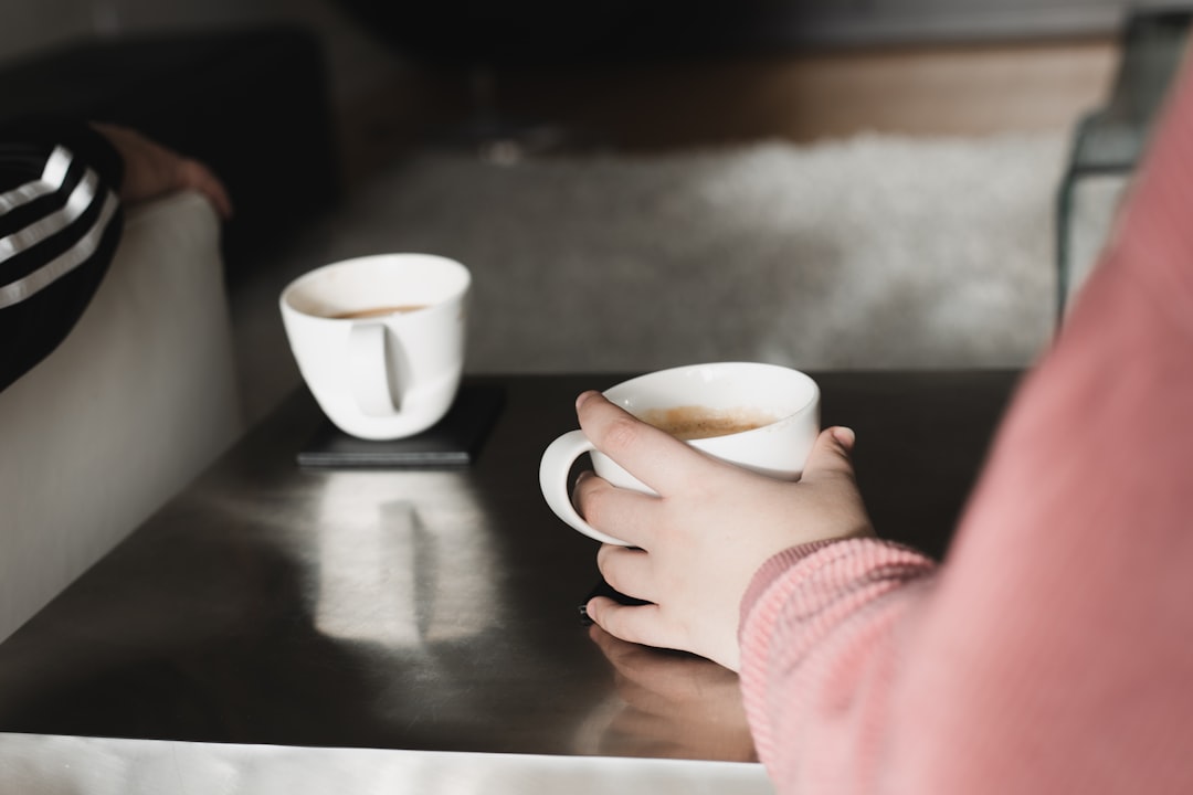 Person relaxing at home with coffee, not stressed about target date funds in their retirement account