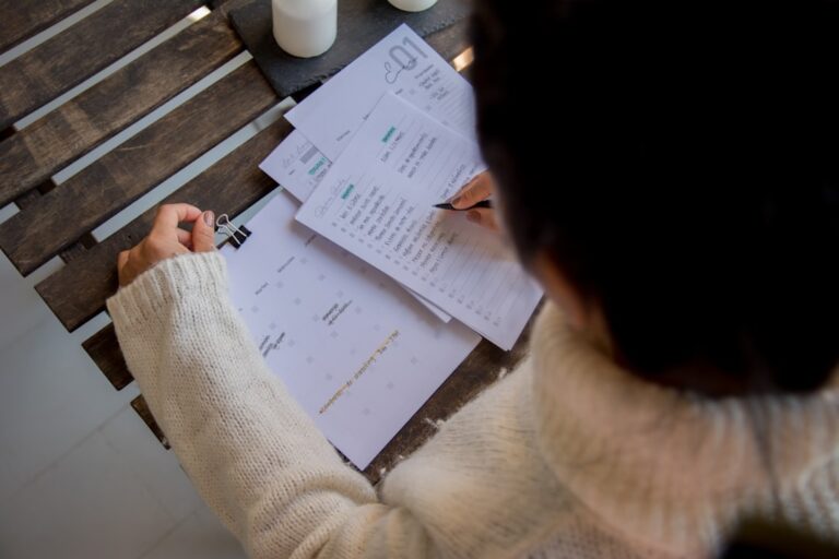 Woman organizing cash into labeled envelopes as part of a sinking fund budgeting system