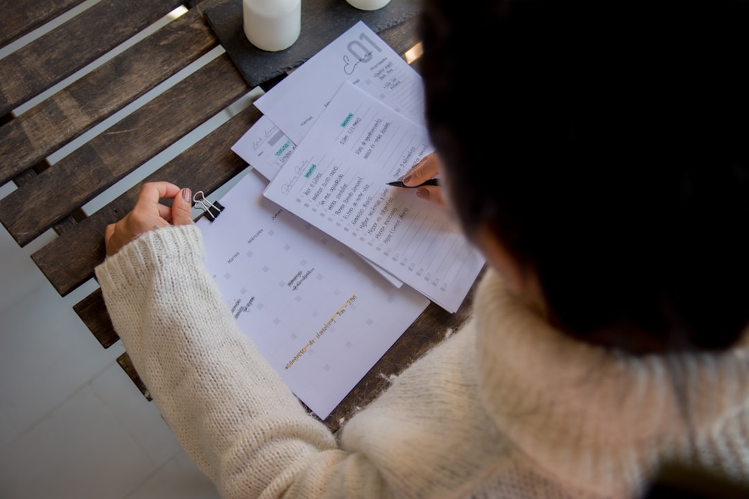 Woman organizing cash into labeled envelopes as part of a sinking fund budgeting system