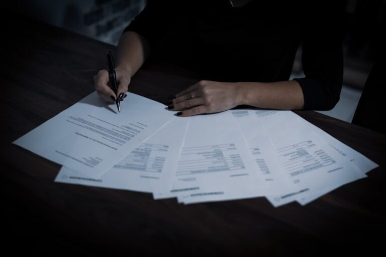Person reviewing 401k rollover paperwork from an old job at a kitchen table