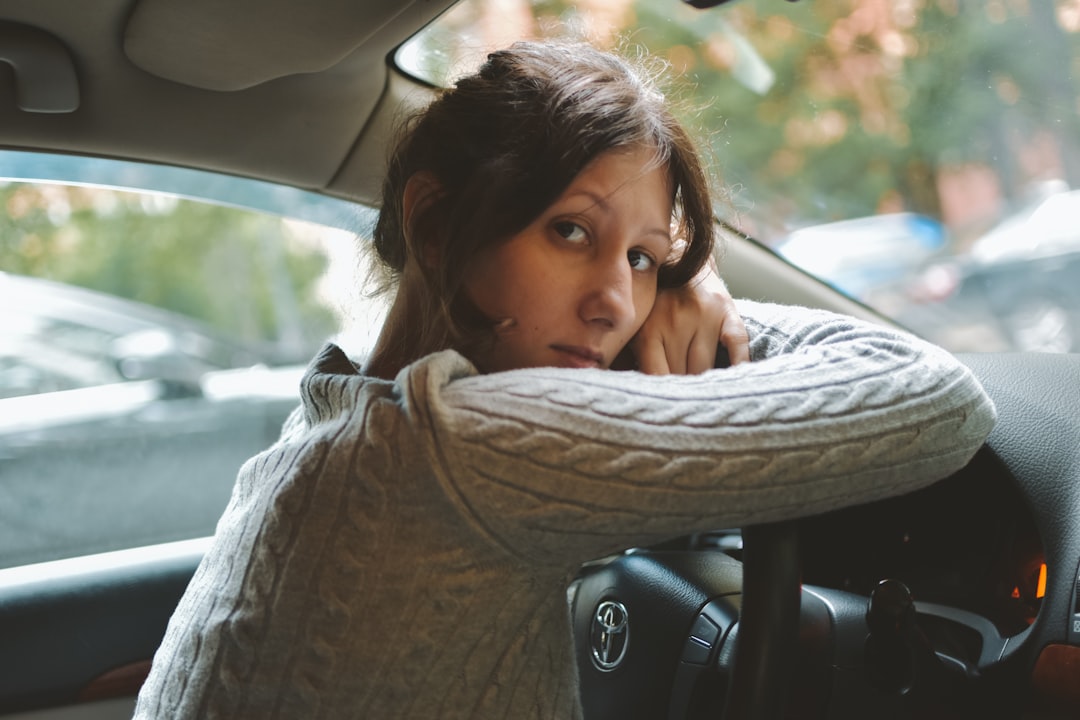 Person reviewing car ownership costs and monthly loan payments at a desk
