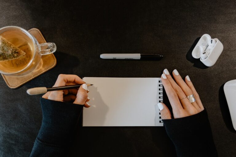 Person writing a debt collection dispute letter at a home desk