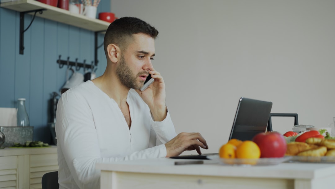Person reviewing finances at kitchen table, deciding between building an emergency fund vs getting the 401k match