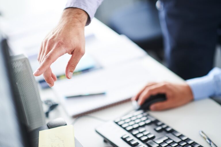Person counting cash at a desk deciding if $100 a month is enough to start investing
