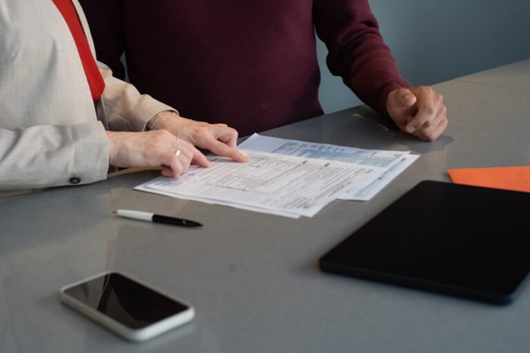 Person reviewing old 401k rollover options at a desk with financial paperwork