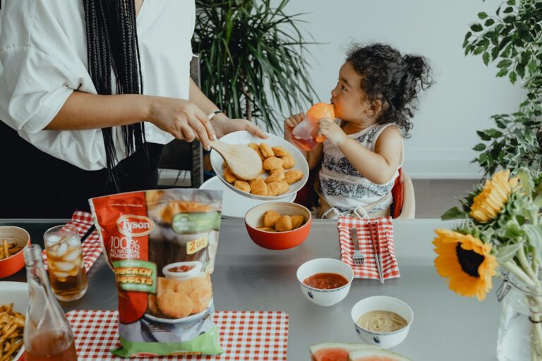 Parent and child sitting at a kitchen table managing finances on one income