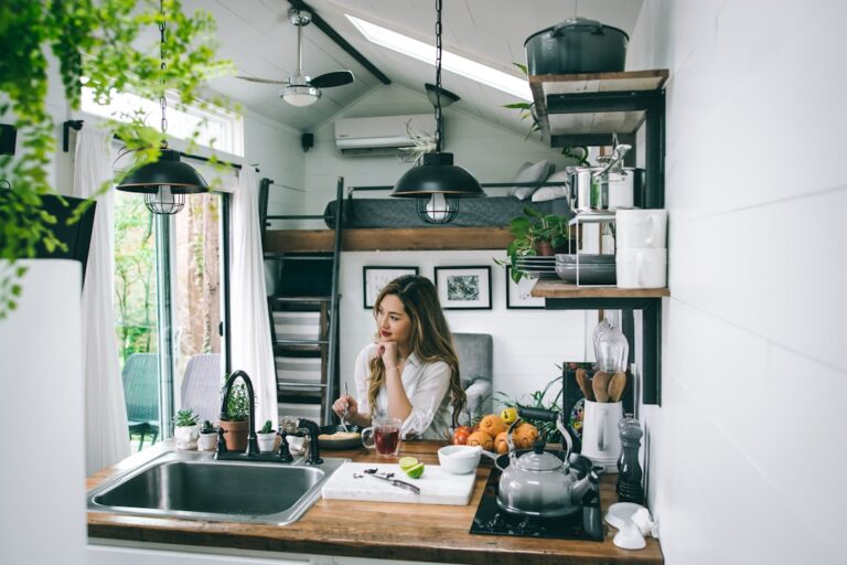Woman counting cash at kitchen table illustrating paycheck to paycheck statistics
