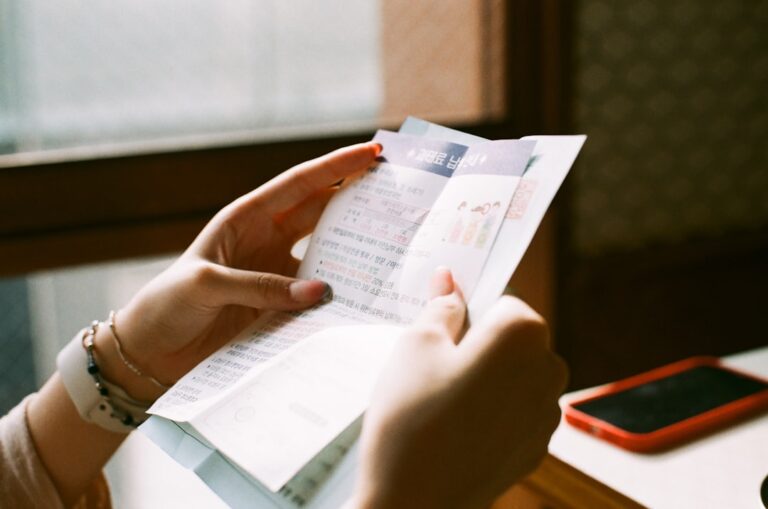 Person sitting at kitchen table reviewing credit documents and rebuilding credit after bankruptcy