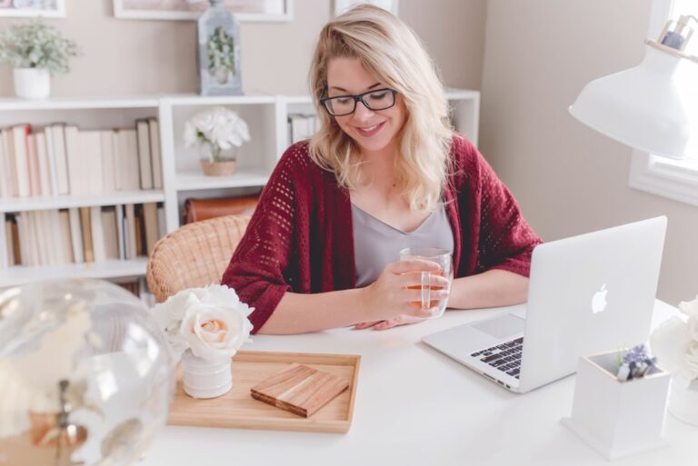 A woman working at a home desk, representing someone planning retirement without an employer 401k