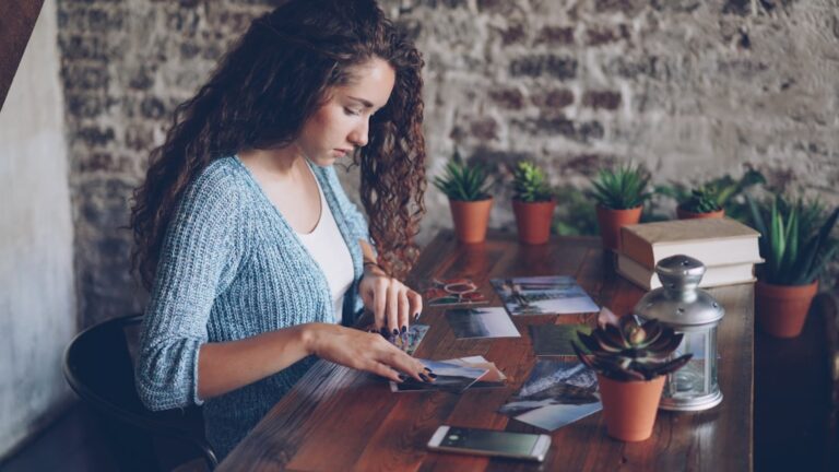 Woman reviewing old debt paperwork at kitchen table, understanding the statute of limitations on debt
