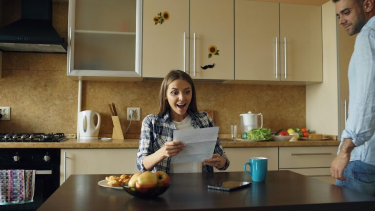Woman carefully counting severance pay cash at kitchen table, managing money after a job loss
