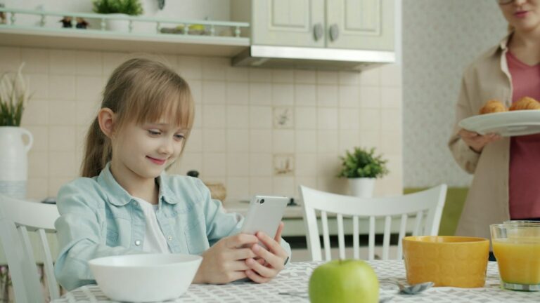 Person calling their credit card company to ask about a credit card hardship program from their kitchen