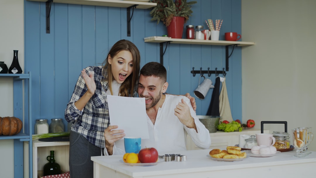 A woman in her 40s reviewing her Social Security estimate paperwork at a kitchen table, learning how to check your Social Security estimate online