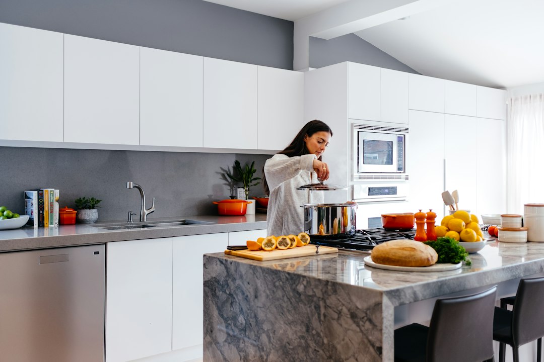 Woman on phone negotiating a medical bill payment plan at her kitchen table