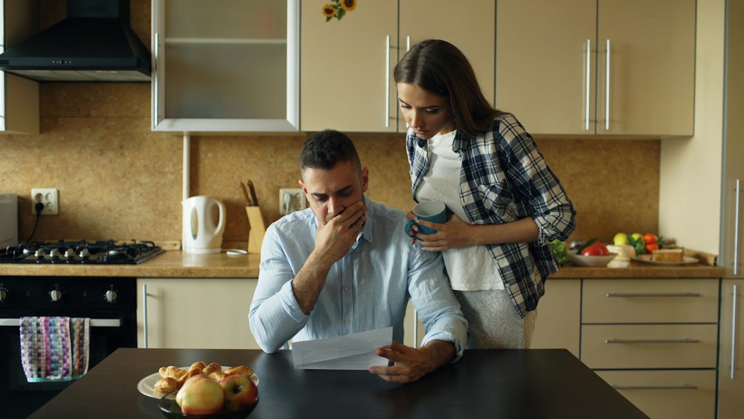 Family reviewing what is a beneficiary designation on financial account paperwork at a kitchen table