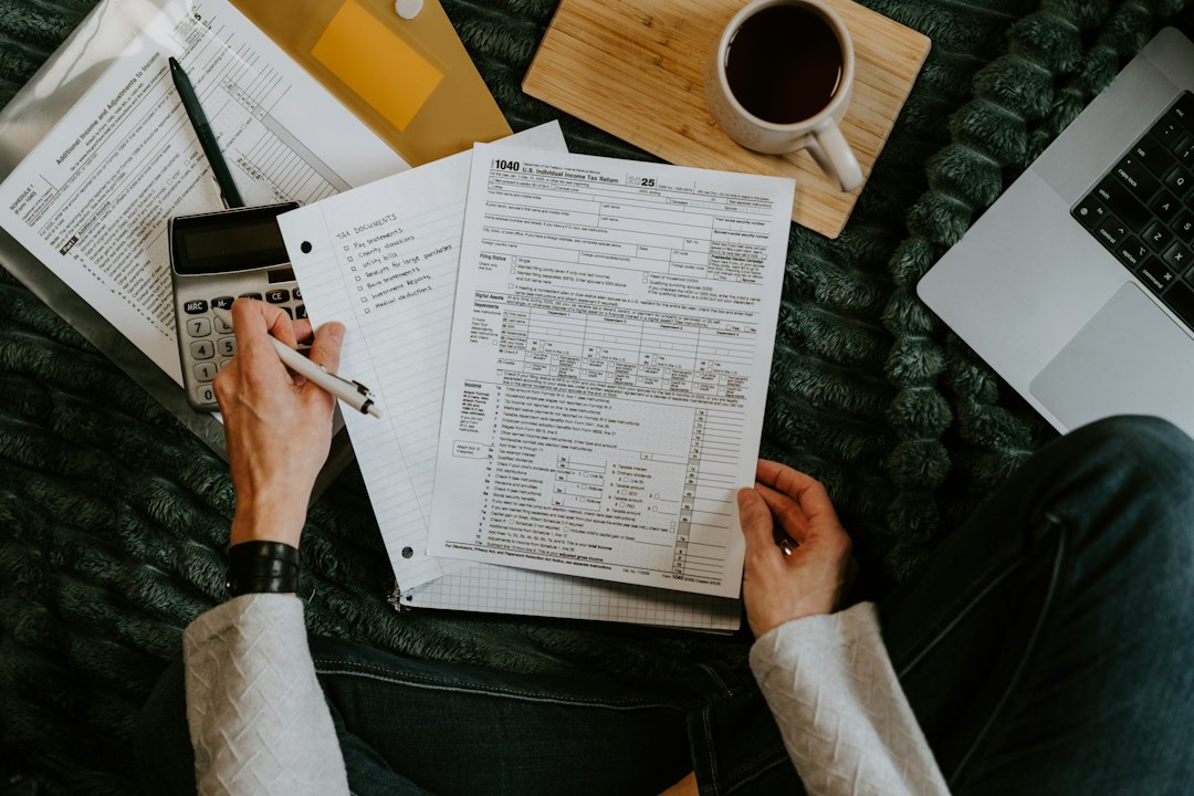 Person at kitchen table reviewing tax documents to understand their marginal tax rate in 2026