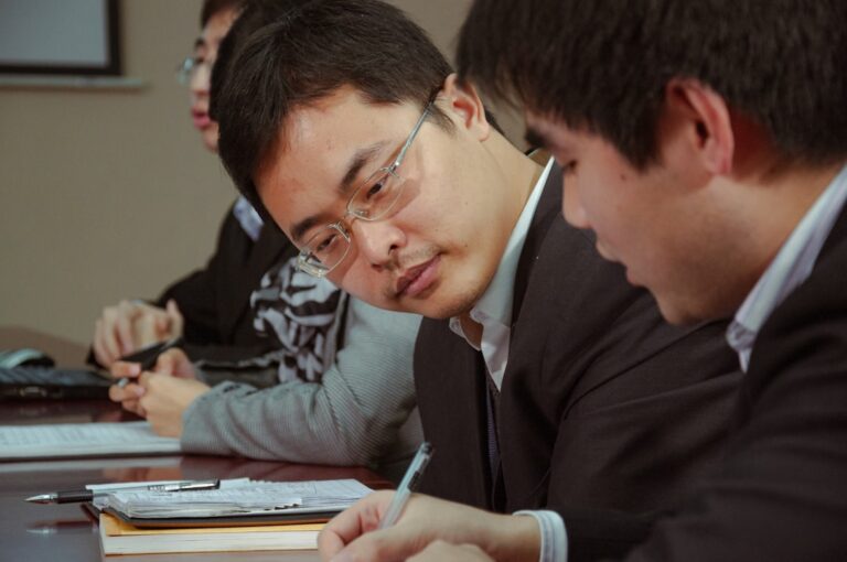 Employee reviewing vesting schedule paperwork at a desk, understanding when employer 401k contributions become theirs