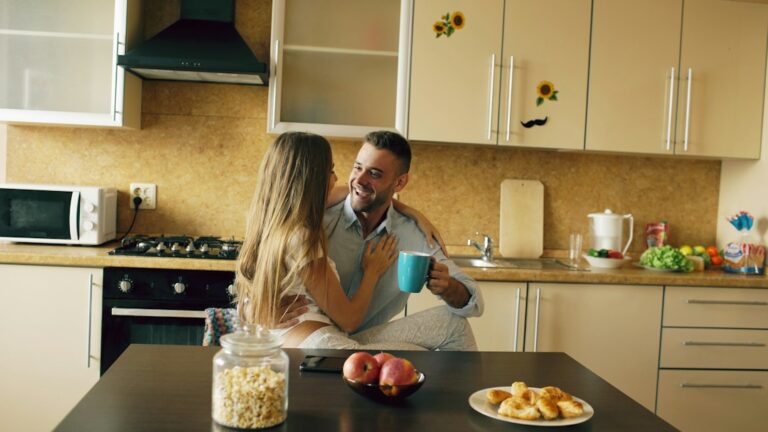Person organizing cash and budget notebook at kitchen table to set up sinking funds for beginners